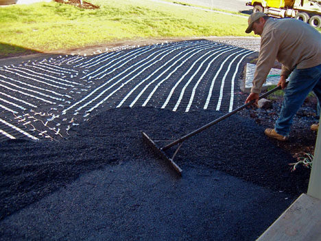 Radiant heat snow melting mats being installed to heat asphalt driveway.